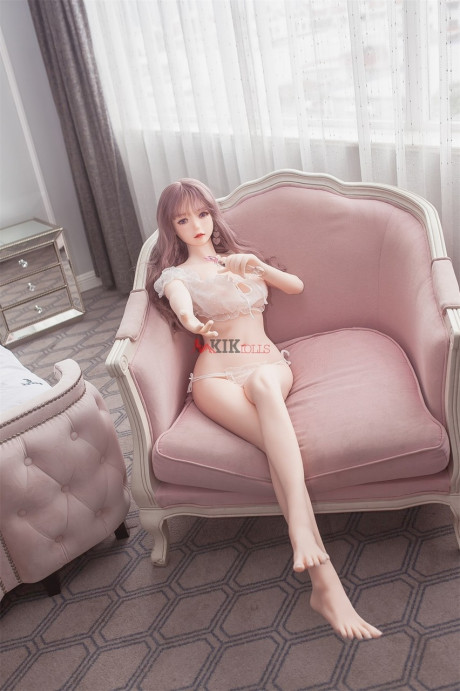 Adorable sex doll Chika showing her perfect boobies and bald twat in the bedroom
