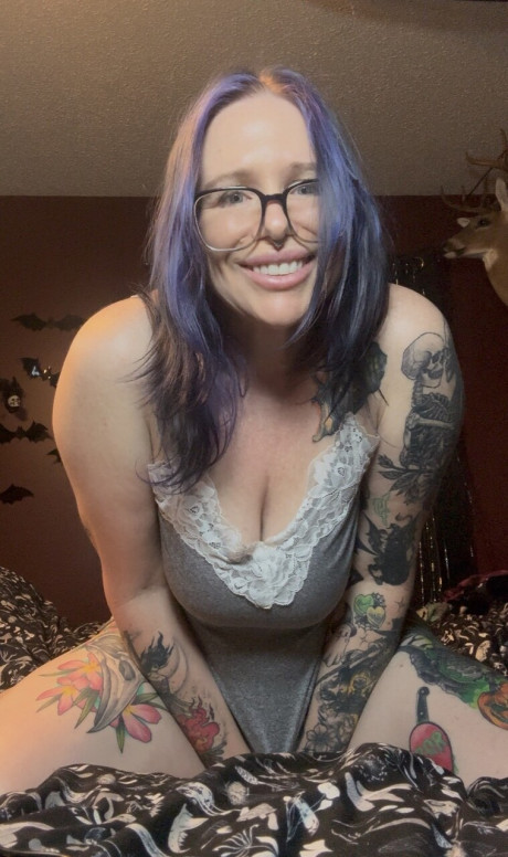 Tattooed amateur shows her titties and cunt before pulling down her hosiery
