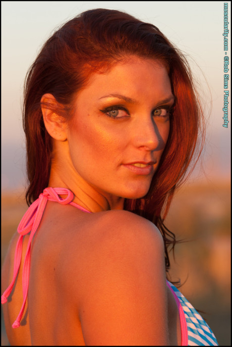 Fit ginger head Tierney Flickler changes from a bikini into athletic wear