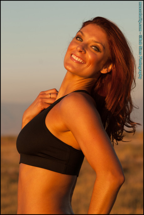 Fit ginger head Tierney Flickler changes from a bikini into athletic wear