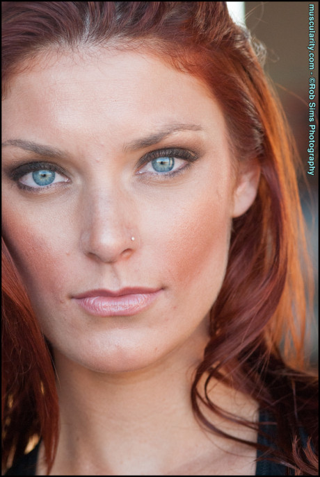 Fit ginger head Tierney Flickler changes from a bikini into athletic wear