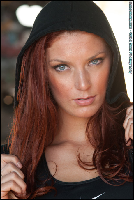 Fit ginger head Tierney Flickler changes from a bikini into athletic wear