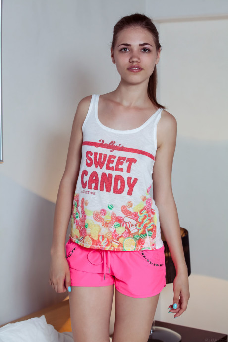 Fine teenie Jasmina eats an ice-cream and strips to pose on a bed