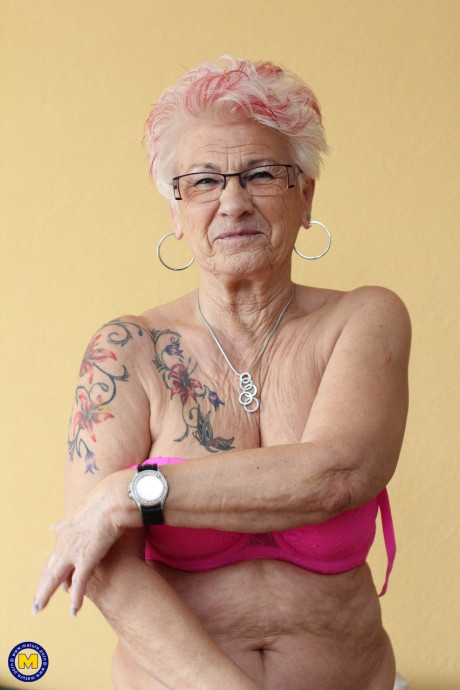 German grandmother Gerdi strips & spreads her attractive shaved mature vagina on a bed
