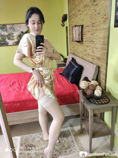 Attractive brunette babe in nylons flaunts her butt & takes selfies in the mirror