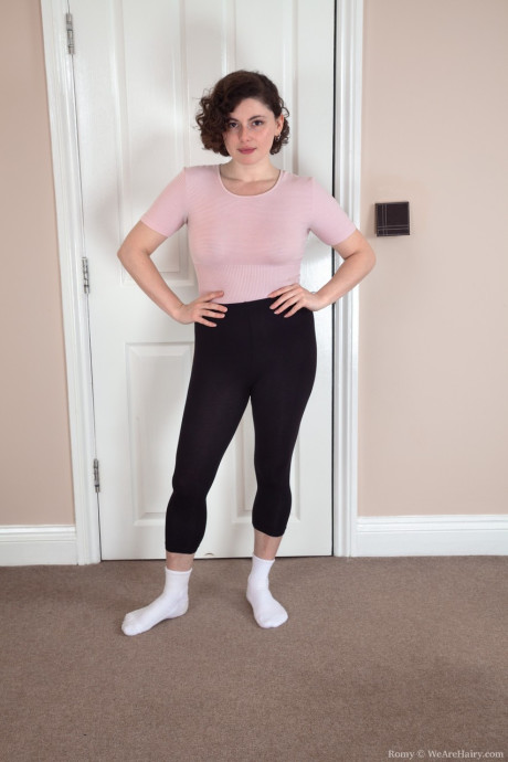 Flexible brunette Romy shows her pubic hair and spreads her round ass cheeks