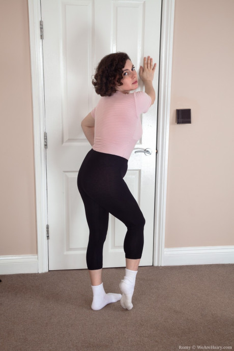 Flexible brunette Romy shows her pubic hair and spreads her round ass cheeks