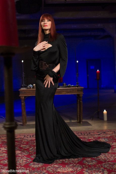 Wild mistress Madeline Marlowe biting a male sub's cock in hot BDSM action