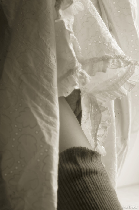 Pantyless babe shows her puffy nipples and twat while posing by the window