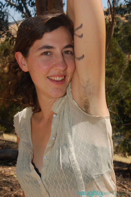 Brunette amateur Artemis shows her tiny titties and rubs her bush outdoors