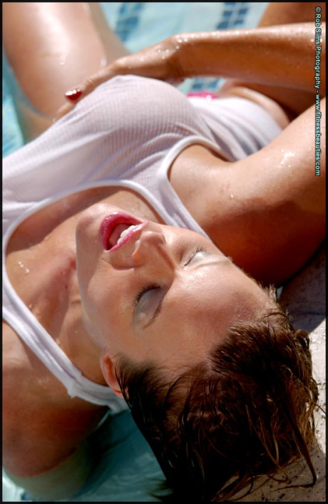 Pretty middle-age chick Tonya Elliott models a wet tank top in a pool