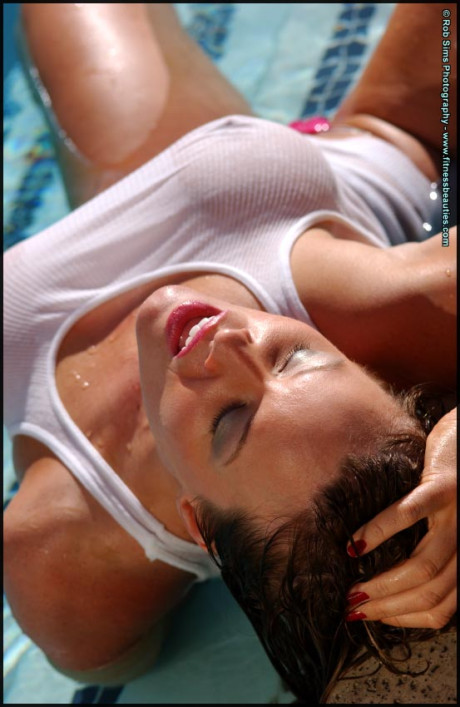 Pretty middle-age chick Tonya Elliott models a wet tank top in a pool