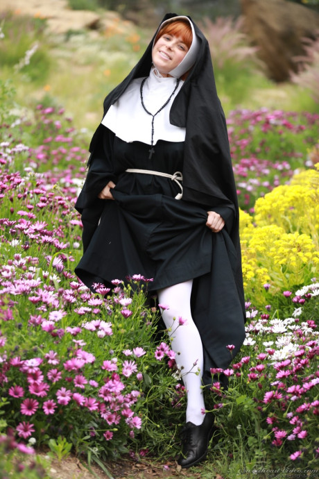 Redheaded nun Penny Pax shows off her large natural titties and and snatch