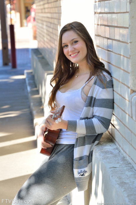 Bosomy babe Summer exposes her giant butt while playing a small guitar in public