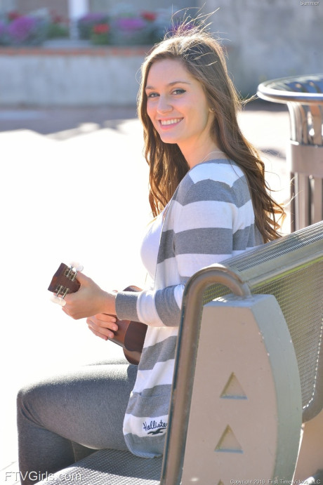 Bosomy babe Summer exposes her giant butt while playing a small guitar in public