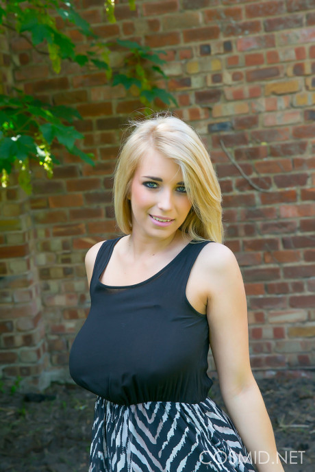 Busty yellow-haired Jodie takes off her clothes outdoors to sun her saggy tits