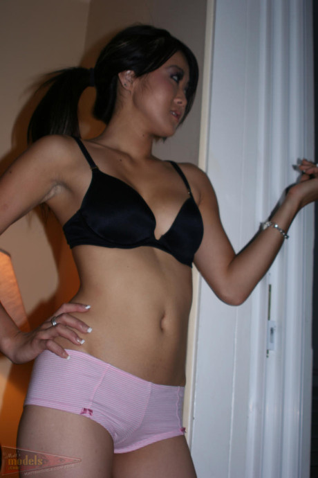 Oriental first timer Taya pauses for a smoke break in her bra and panties