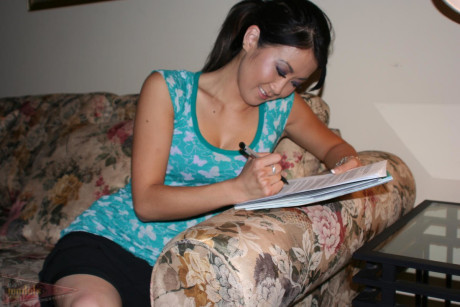 Oriental first timer Taya pauses for a smoke break in her bra and panties