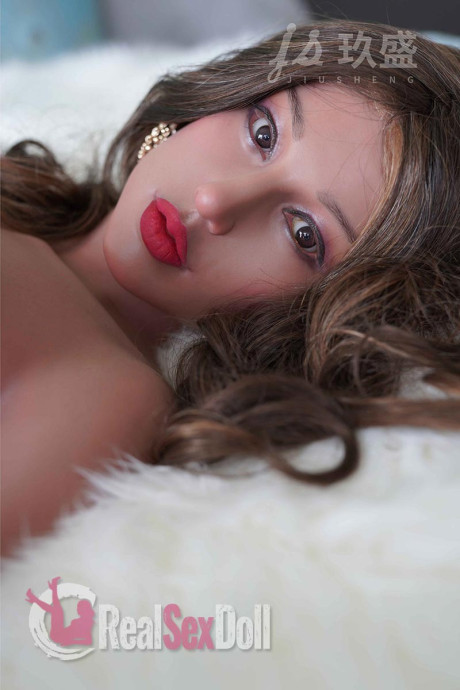 Solo model with red lips and big melons poses a clothed and a nude sex doll