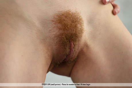 Gorgeous red hair Adel P lounging naked showing off her silky pussy close up