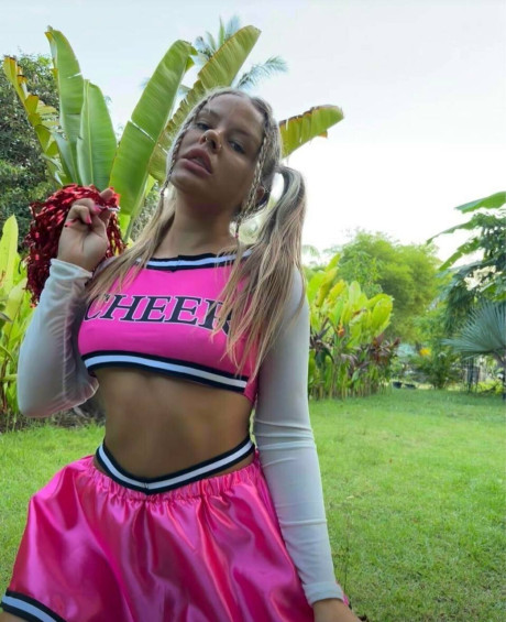 Blonde cheerleader flashes her firm tits & shows off her hot ass outdoors