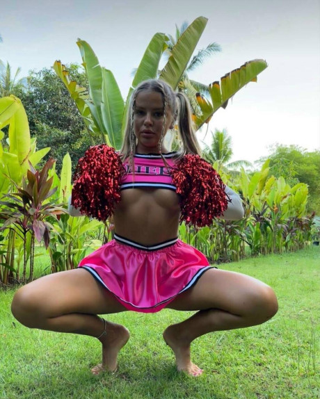 Blonde cheerleader flashes her firm tits & shows off her hot ass outdoors