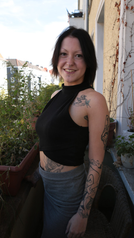 Tattooed German skank GF lady sports a ass plug while posing in the naked