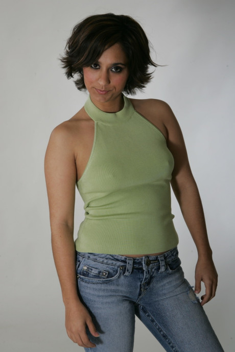 Fine brunette model Shandra posing in her provocative outfits in a solo