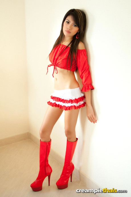 Petite Thai teenie Fa poses in her attractive outfit & shows her melons & bald holes