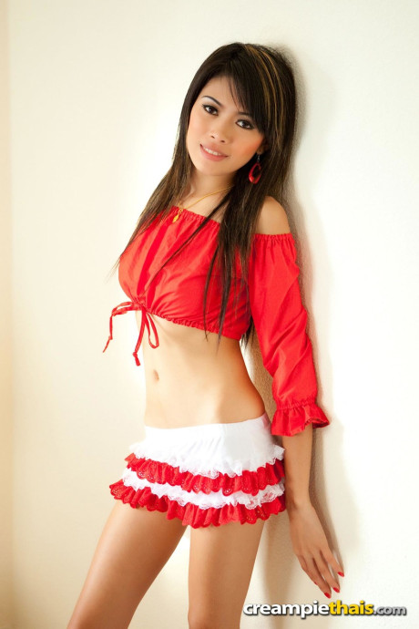 Petite Thai teenie Fa poses in her attractive outfit & shows her melons & bald holes