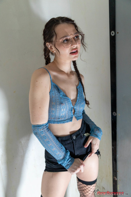 Liz Jordan wears her glasses during a blowbang in an adult tape store