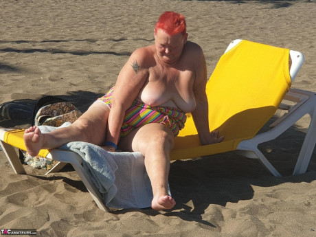 Cougar SSBBW Val Gasmic dyes her hair red before exposing herself on the beach