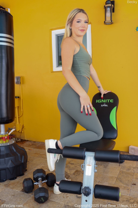 Yellow-haired hottie Becky shows her small tan lined boobs from athletic wear