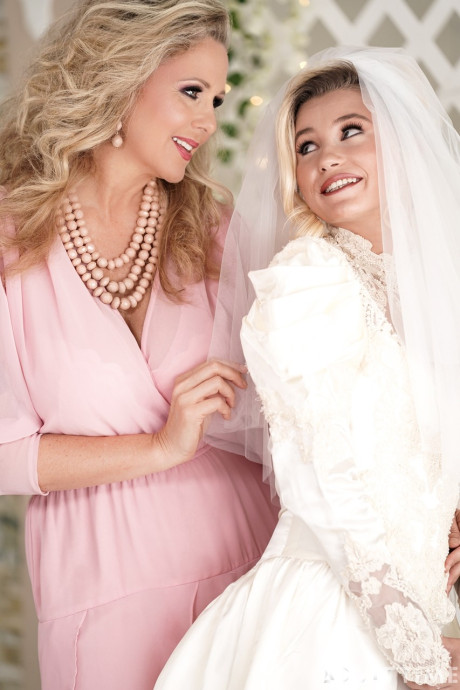 Carolina Sweets is affixed with a garter before a lesbian wedding to Julia Ann