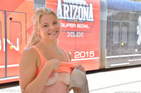 Athletic blondy babe with a nice butt spreads her pussy in public