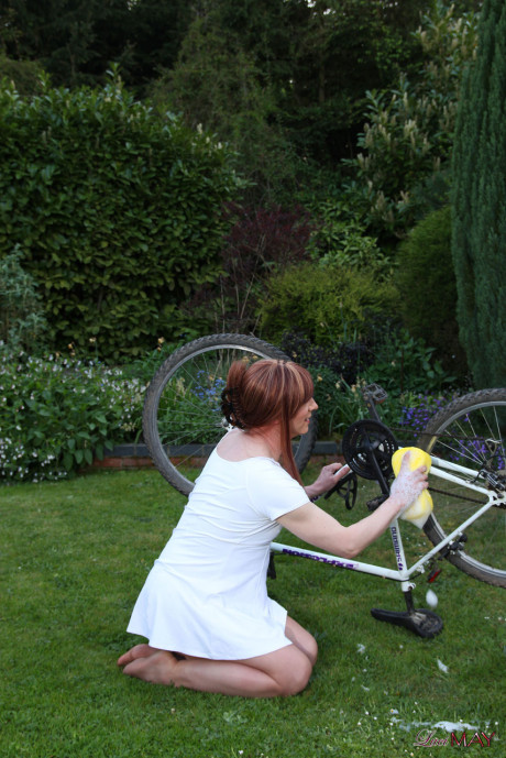 Fine Lucimay gets very soapy as she cleans her bike