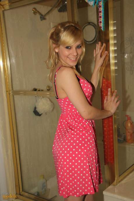 Blondy first timer Emma exposes her attractive booty before taking a bath