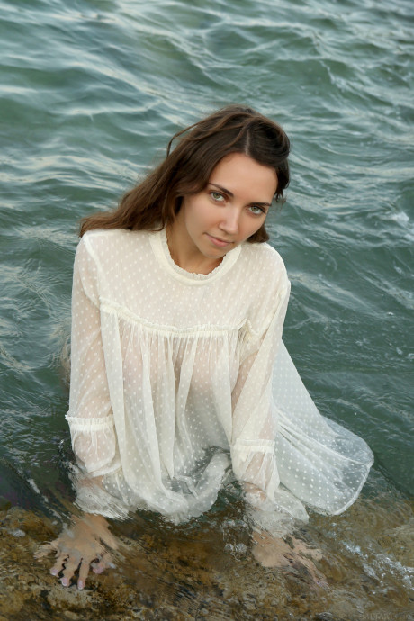 Pretty teenie Danniela shows her sweet tasty boobs & flaunts her hairy pussy in the sea