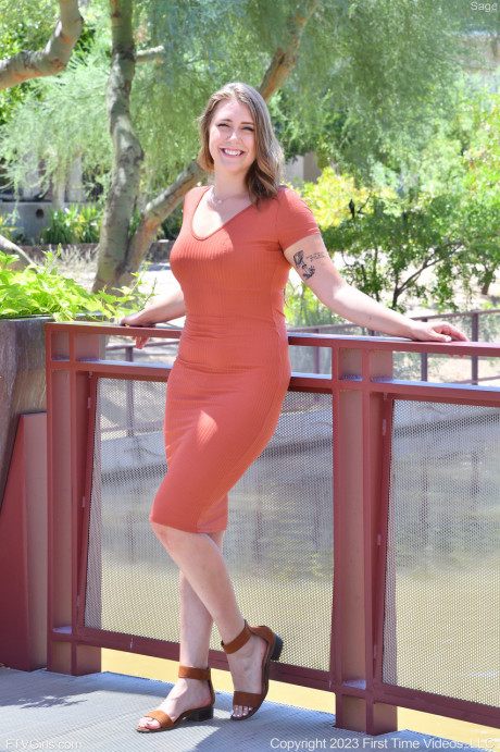 Glamorous brunette babe Sage	flashing her panties and bra in public