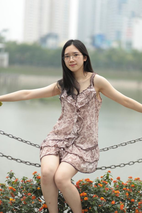 Good-looking chinese sexpot teases in a lovely short dress outdoors