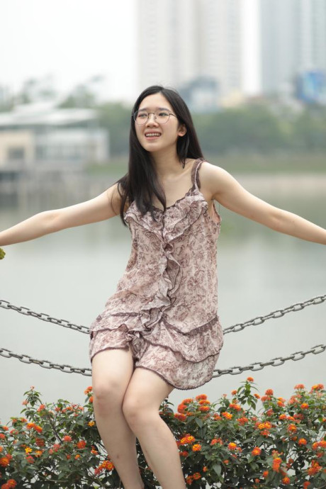 Good-looking chinese sexpot teases in a lovely short dress outdoors