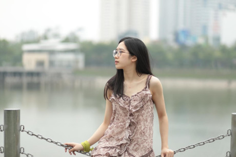 Good-looking chinese sexpot teases in a lovely short dress outdoors