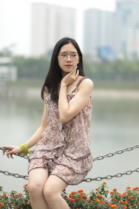 Good-looking chinese sexpot teases in a lovely short dress outdoors