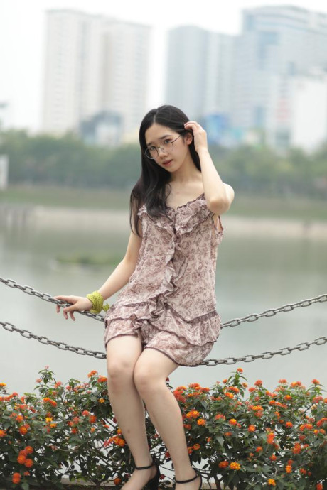 Good-looking chinese sexpot teases in a lovely short dress outdoors