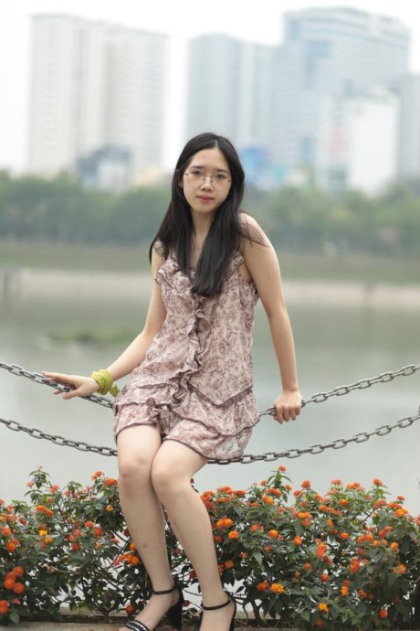 Good-looking chinese sexpot teases in a lovely short dress outdoors