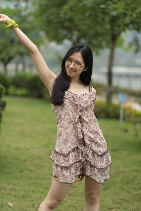 Good-looking chinese sexpot teases in a lovely short dress outdoors