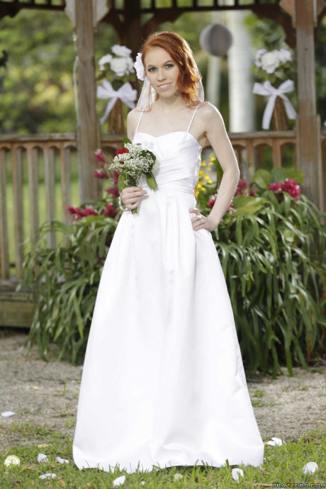 Charming bride Dolly Little strips off her hot wedding dress outdoors