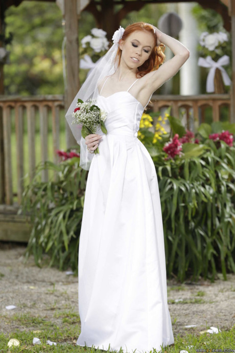 Charming bride Dolly Little strips off her hot wedding dress outdoors
