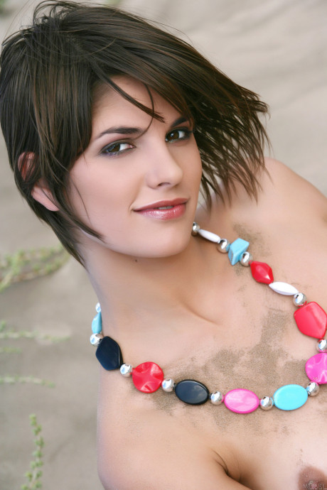 Undressed teen babe Demi A posing in the sand and teasing with her lovely body
