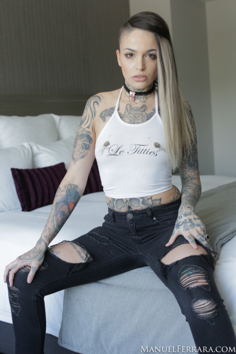Tattooed lady GF girl Leigh Raven wears a ebony choker while getting nude